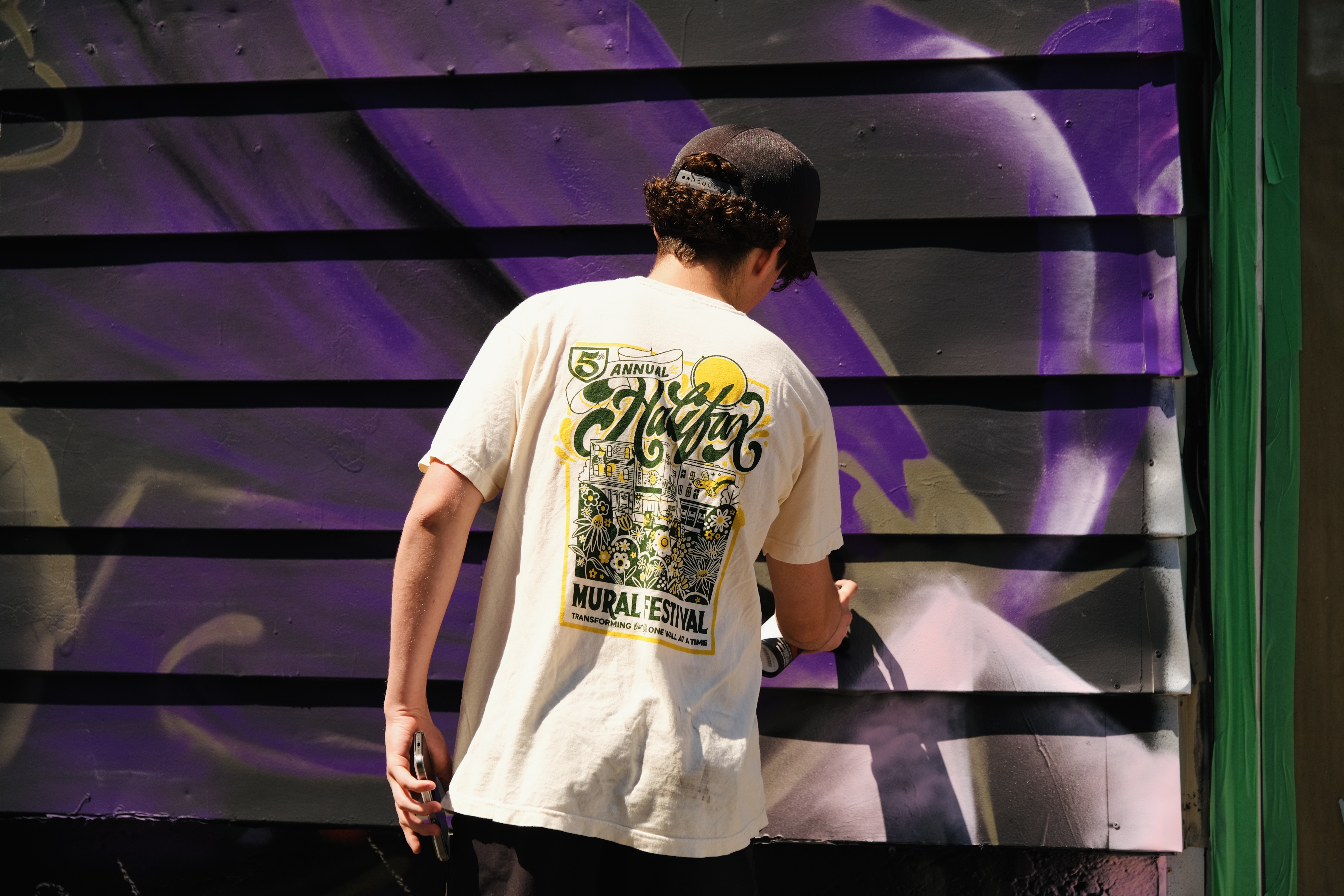 Emmett painting a purple mural