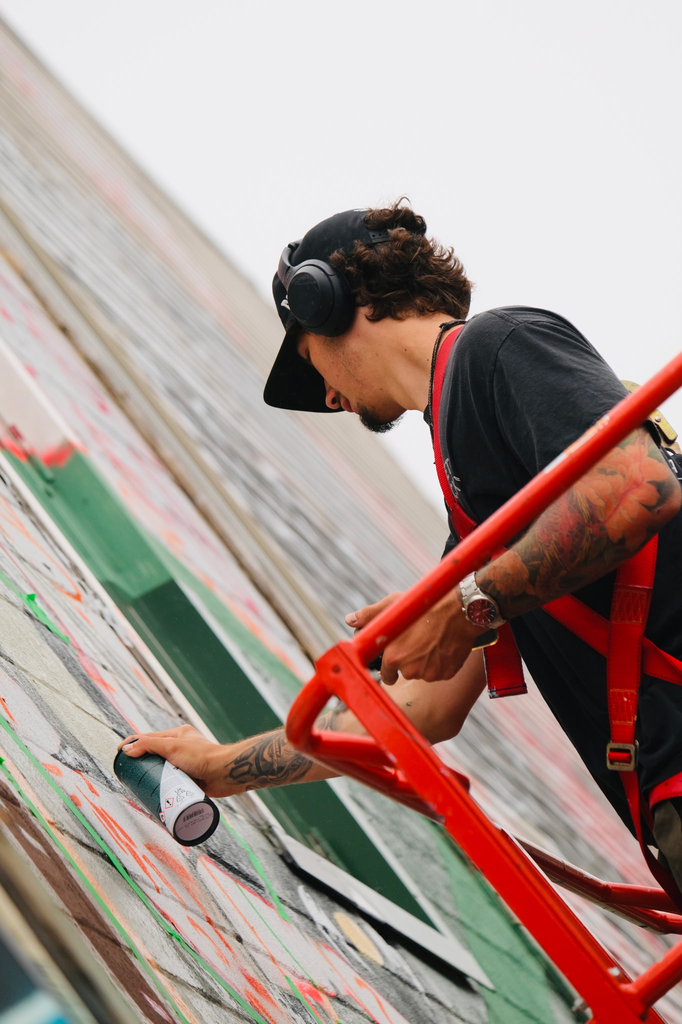 Nick painting a mural from a lift