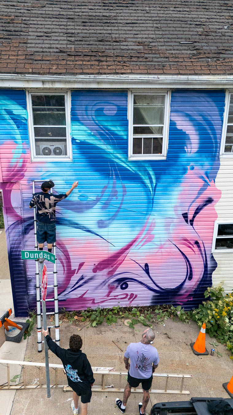 Emmett and Nick working together on a mural